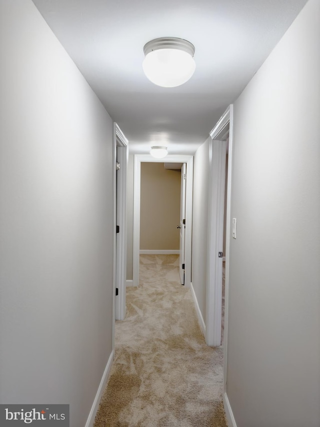 hall with light colored carpet