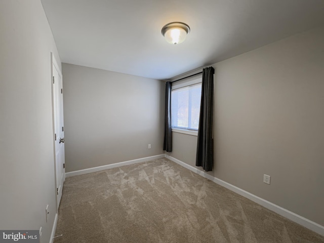 empty room featuring light carpet