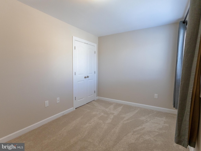 unfurnished bedroom with light carpet