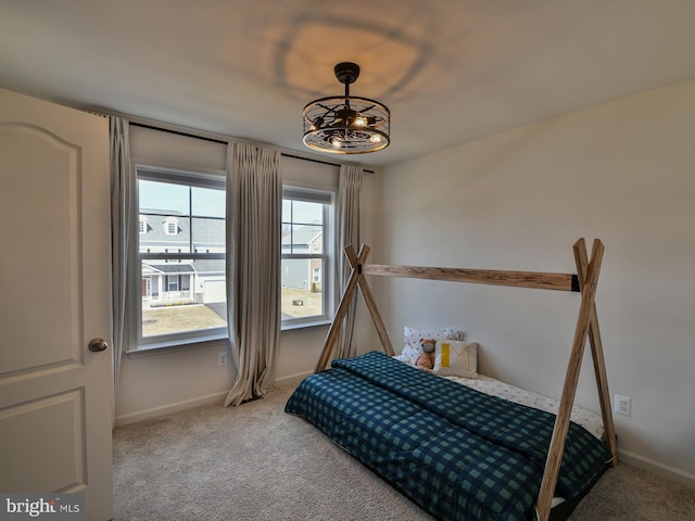 carpeted bedroom featuring baseboards