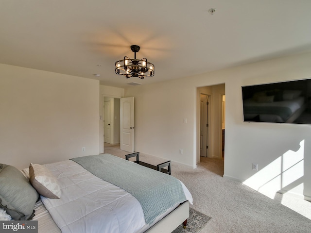 bedroom with an inviting chandelier, baseboards, and carpet