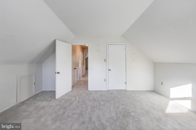 bonus room featuring light colored carpet and lofted ceiling