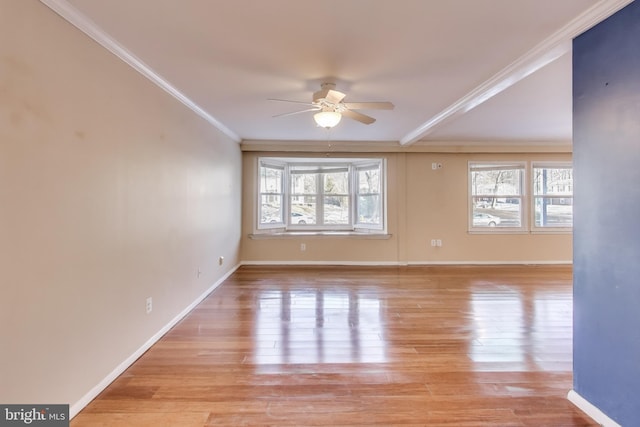 unfurnished room with ornamental molding, ceiling fan, and light wood-type flooring