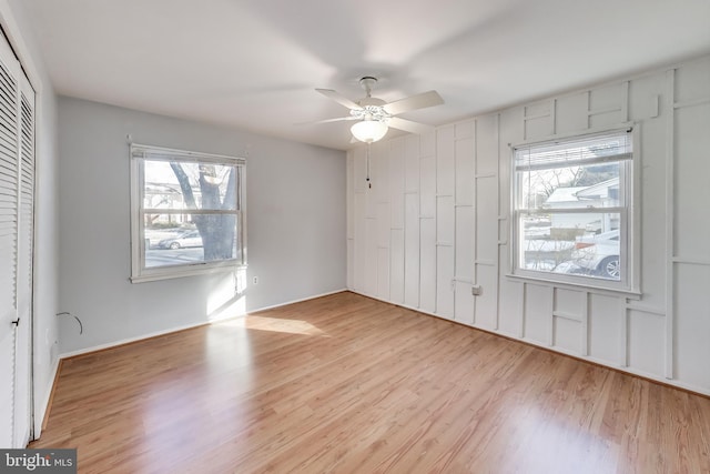 unfurnished bedroom with light hardwood / wood-style flooring, a closet, and ceiling fan