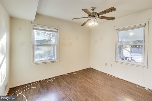 spare room with ceiling fan and wood-type flooring