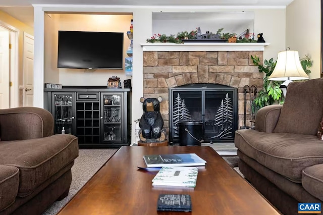 living room featuring a stone fireplace