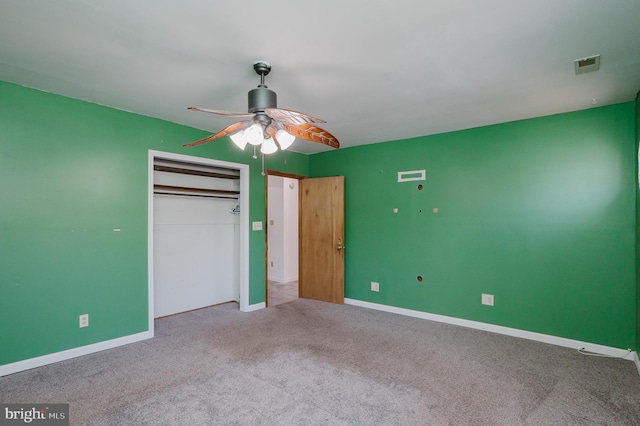 unfurnished bedroom featuring light colored carpet, a closet, and ceiling fan