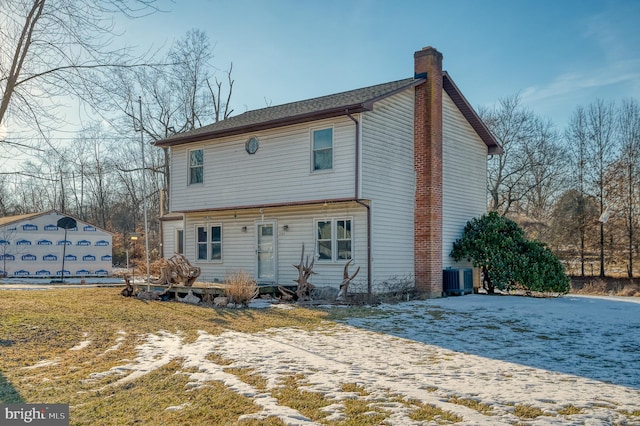 rear view of property with cooling unit