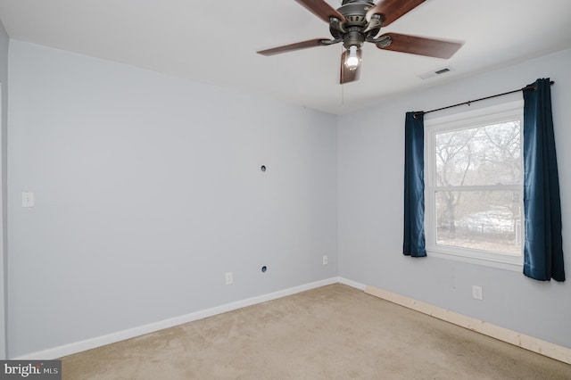 carpeted spare room with ceiling fan