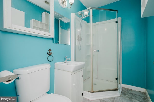 bathroom with vanity, toilet, and a shower with door