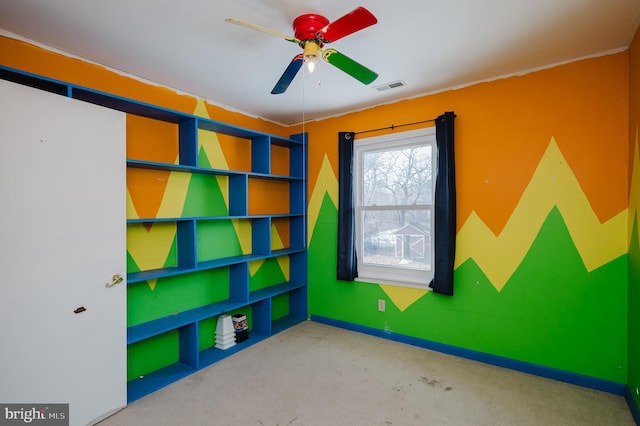 playroom featuring ceiling fan and concrete floors