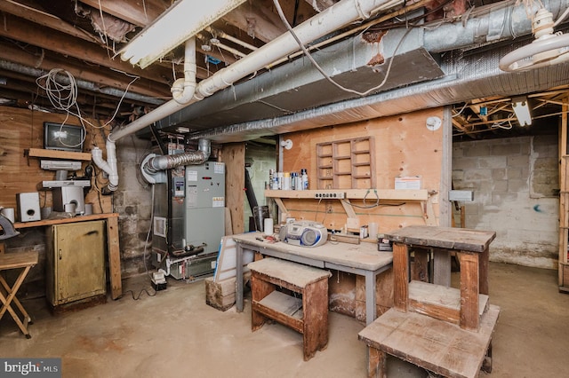 basement with heating unit and a workshop area