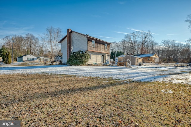 snow covered property featuring a yard