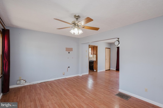 unfurnished room with a textured ceiling, ceiling fan, and light wood-type flooring