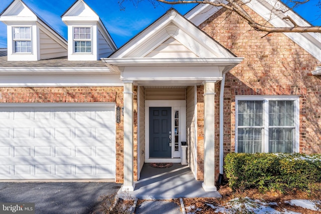 doorway to property with a garage