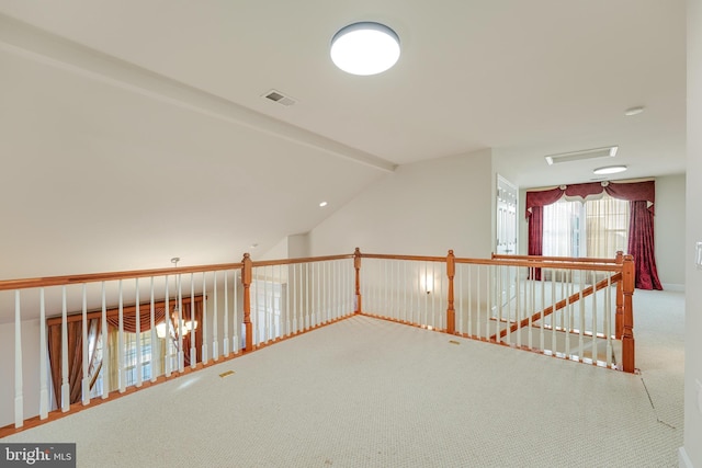 interior space with carpet floors and vaulted ceiling