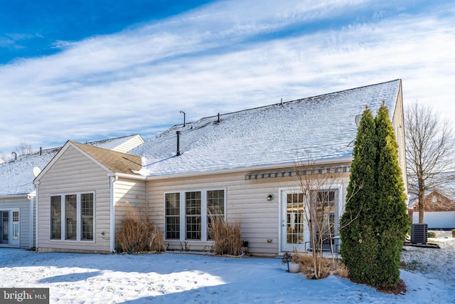 snow covered property featuring cooling unit