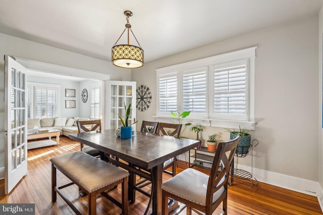 dining room with french doors and hardwood / wood-style floors