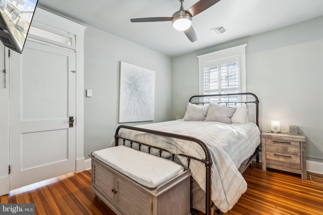 bedroom featuring dark hardwood / wood-style floors and ceiling fan