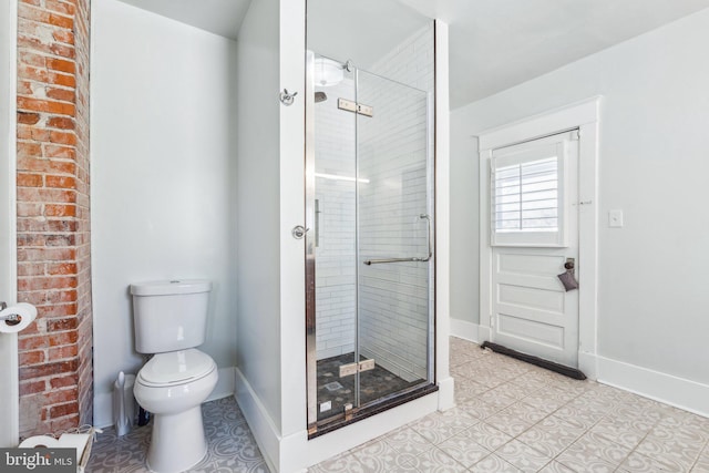 bathroom with tile patterned flooring, a shower with shower door, and toilet