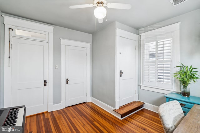 interior space featuring ceiling fan and dark hardwood / wood-style flooring