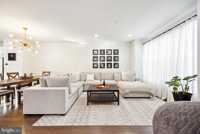 living room with an inviting chandelier and hardwood / wood-style flooring