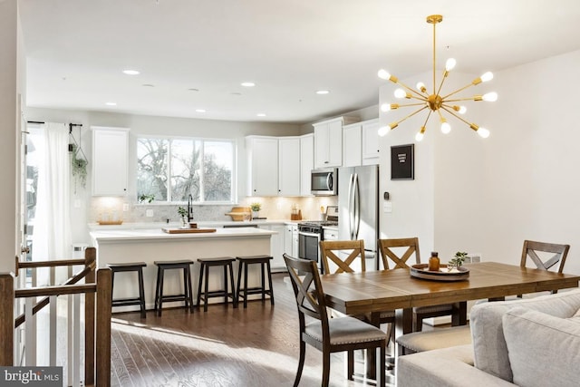 dining area featuring dark hardwood / wood-style flooring and a notable chandelier