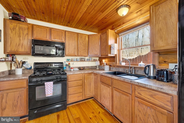 kitchen with light wood-type flooring, black appliances, wooden ceiling, and a sink