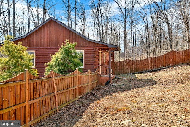 view of side of property with fence private yard and log siding