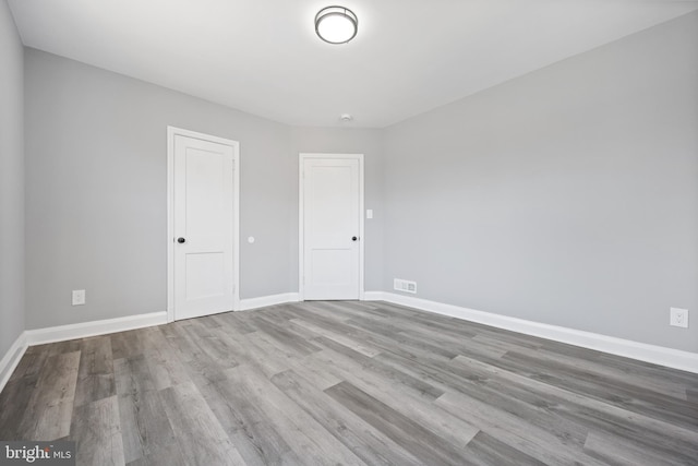 spare room featuring light hardwood / wood-style floors