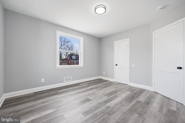 spare room with light hardwood / wood-style flooring