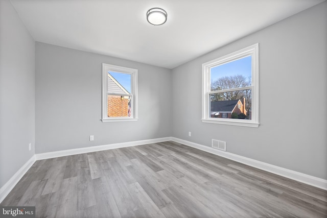 empty room featuring light hardwood / wood-style flooring and a healthy amount of sunlight