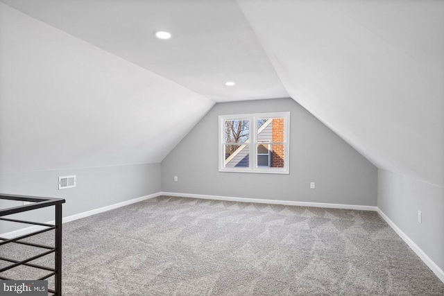 additional living space with lofted ceiling and carpet