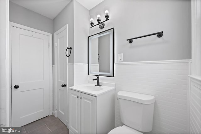 bathroom featuring tile patterned floors, toilet, and vanity