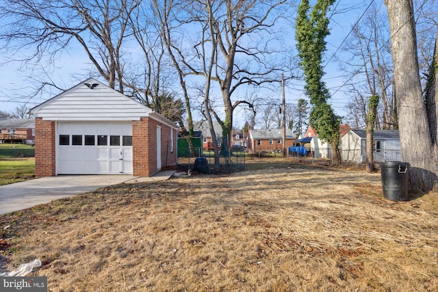 view of yard featuring a garage and an outbuilding