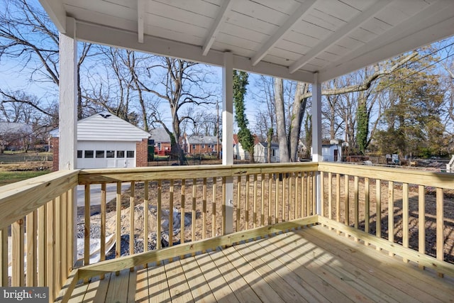 deck featuring an outbuilding and a garage