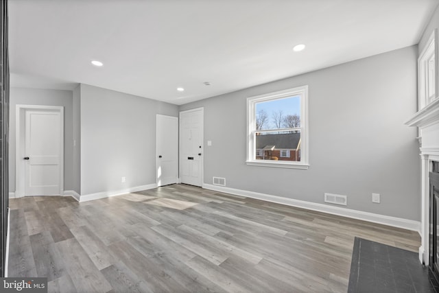 unfurnished living room featuring light hardwood / wood-style flooring