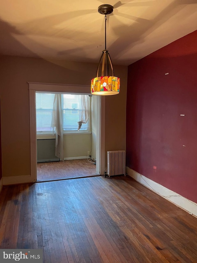 unfurnished dining area with radiator and hardwood / wood-style floors