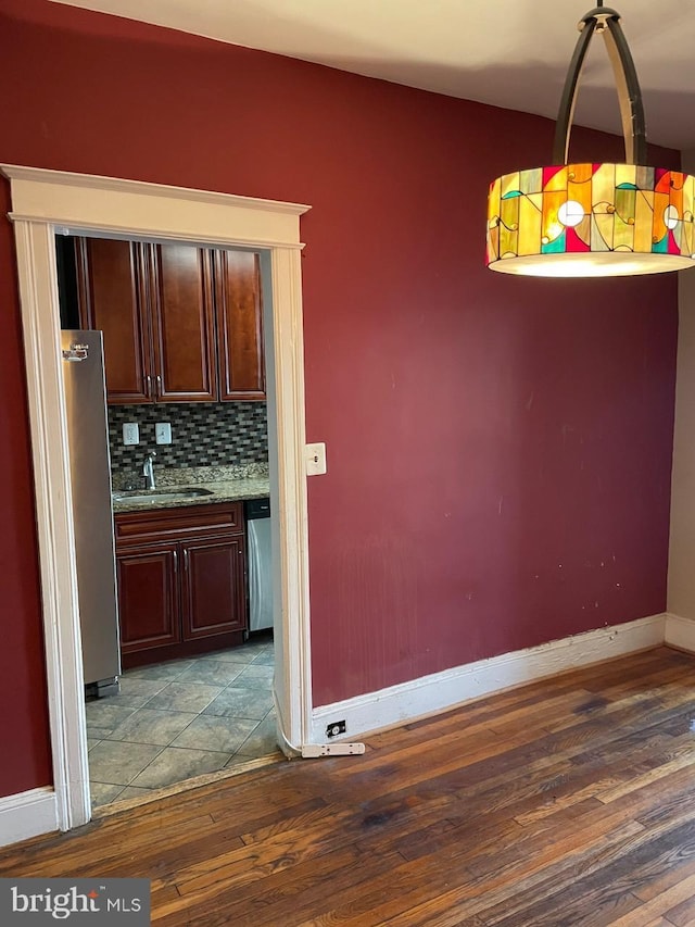 unfurnished dining area with wood-type flooring and sink