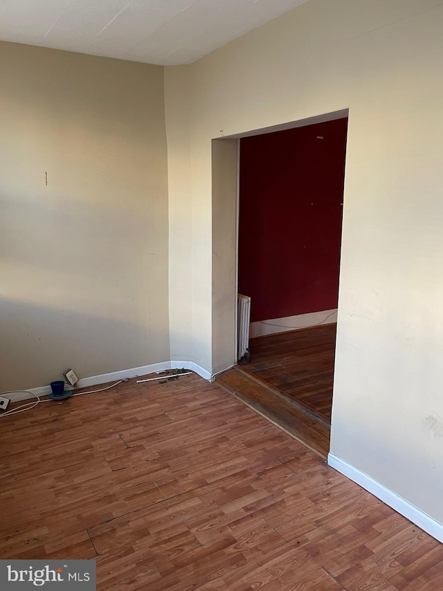 unfurnished room with hardwood / wood-style floors