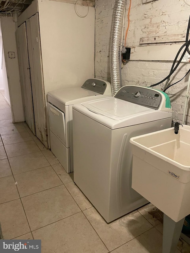 laundry room with light tile patterned floors and washer and dryer