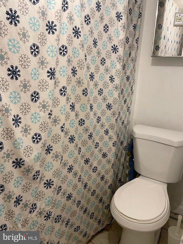 bathroom featuring tile patterned flooring and toilet