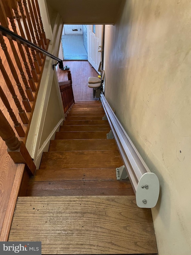 stairway featuring hardwood / wood-style floors