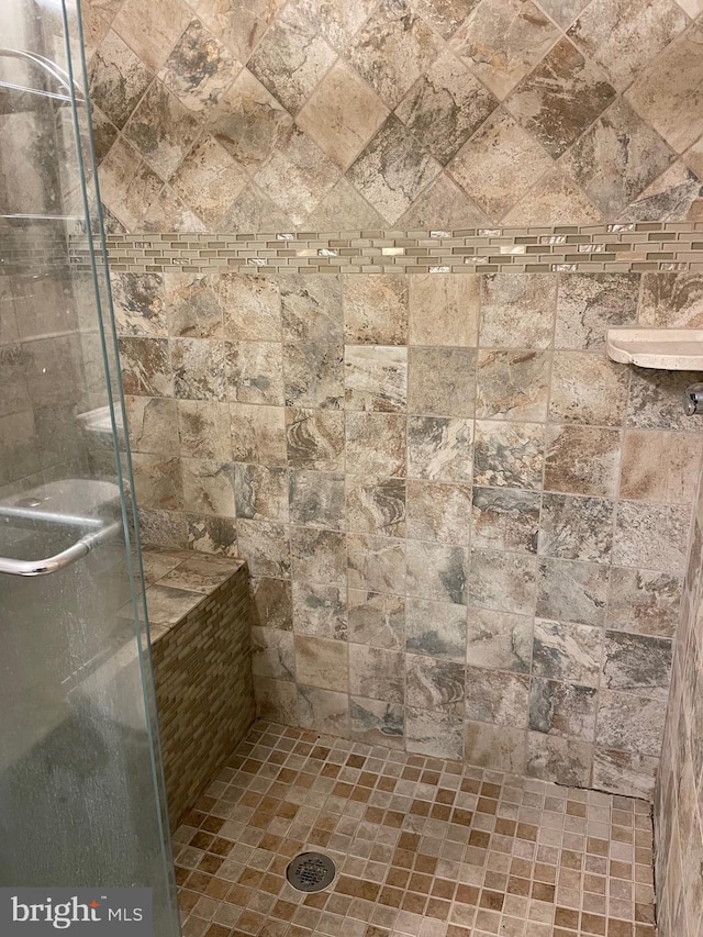 bathroom with tiled shower