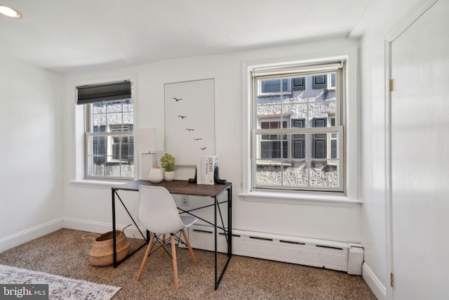 carpeted home office with a baseboard heating unit