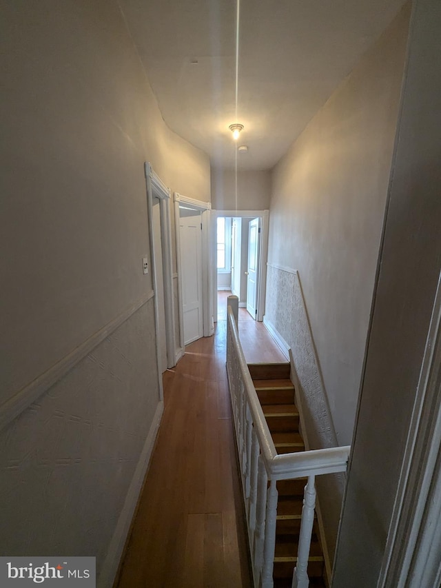 hallway with wood-type flooring