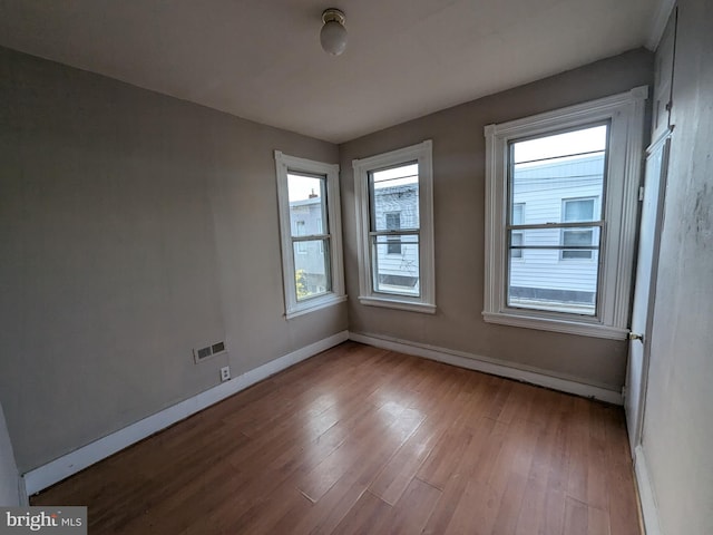 unfurnished room with light hardwood / wood-style floors