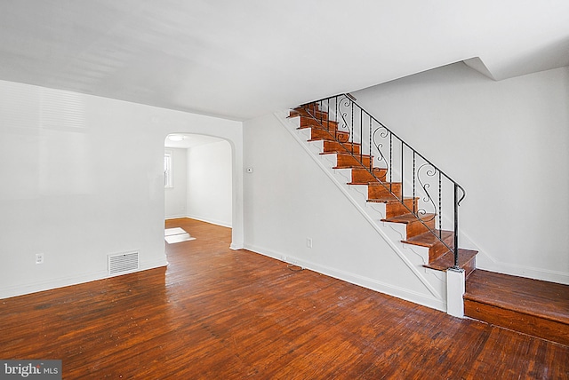 stairway featuring hardwood / wood-style flooring