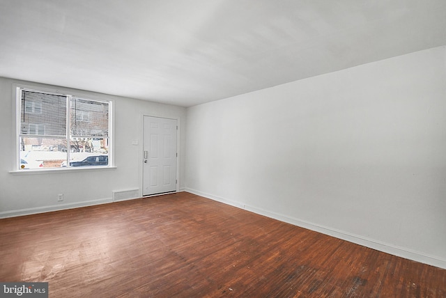 unfurnished room with hardwood / wood-style flooring