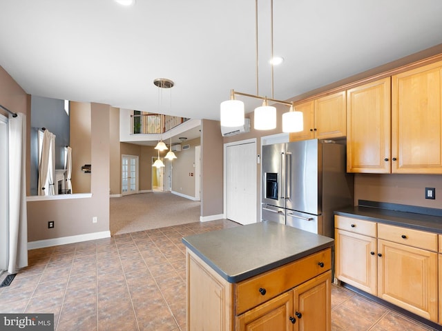 kitchen featuring pendant lighting, dark countertops, high end fridge, light brown cabinetry, and open floor plan